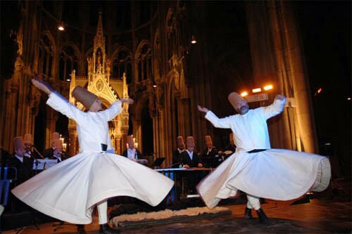 Whirling dervishes dancing in a Catholic Cathedral